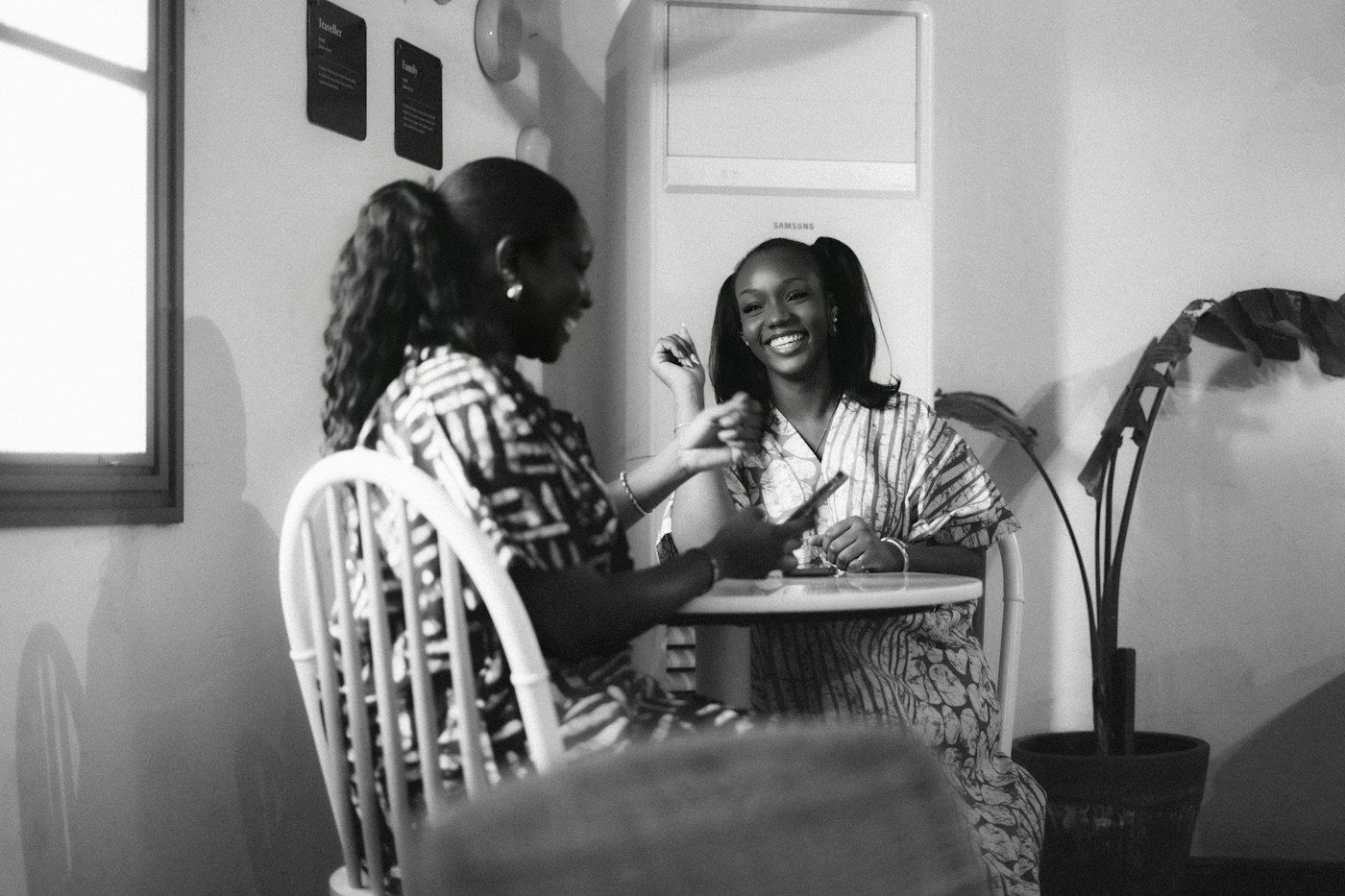 Two women talking together at a café table